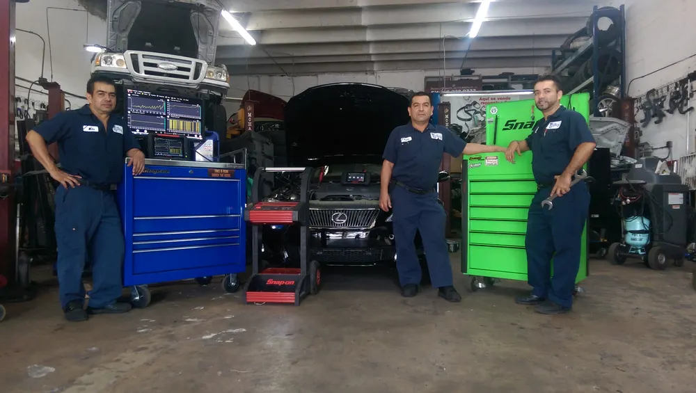 The Pacho's Quality Auto Repair technicians in the service bay with their tool chests