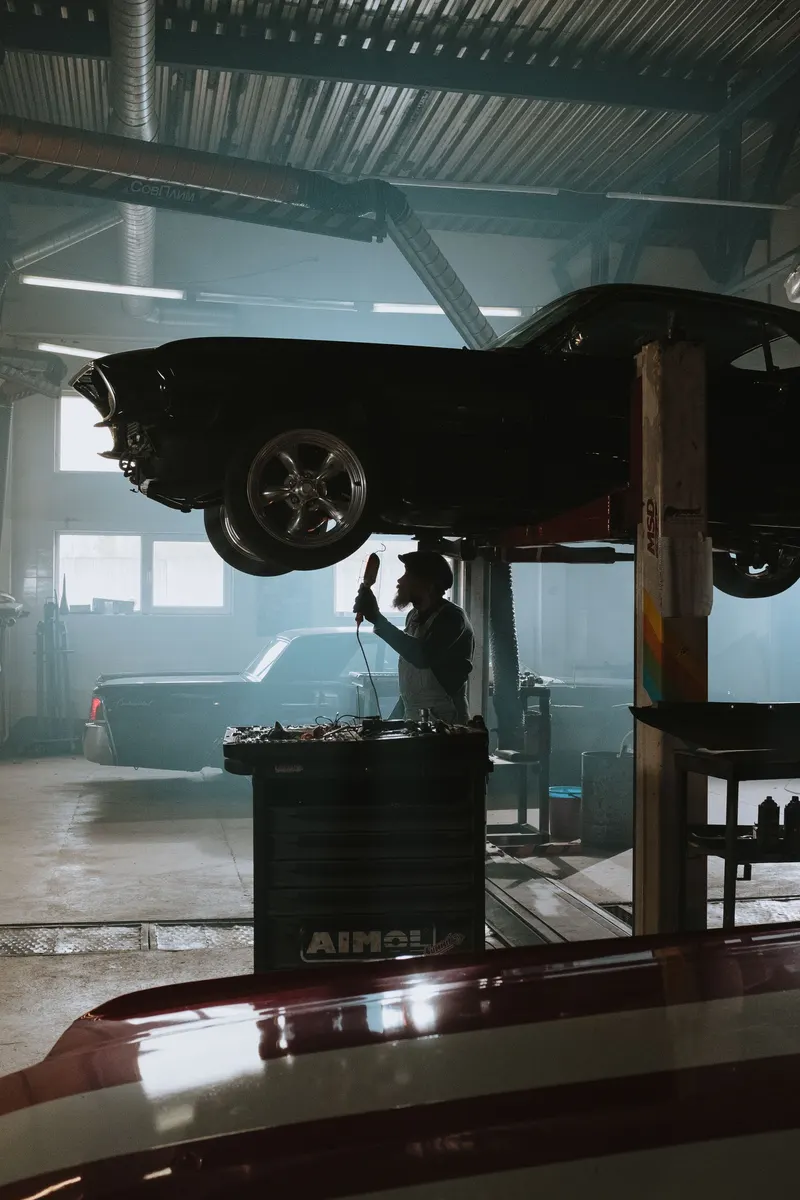 Vehicle raised on a lift inside the service bay